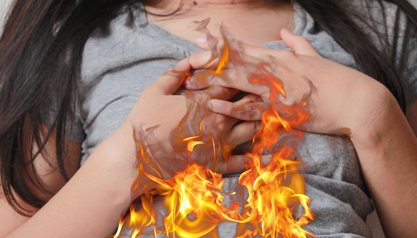 SIBO & SIFO Image showing Woman Overheating on the Torso holding her Chest