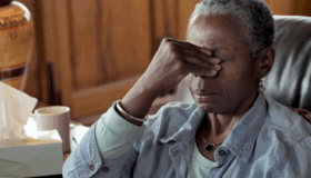 Sinus Related Nasal Congestion | Image of a black woman holding her sinuses