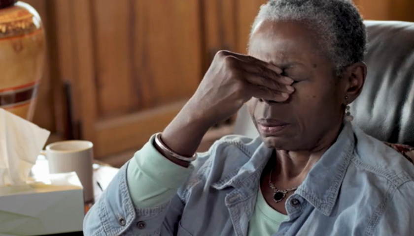 Sinus Related Nasal Congestion | Image of a black woman holding her sinuses